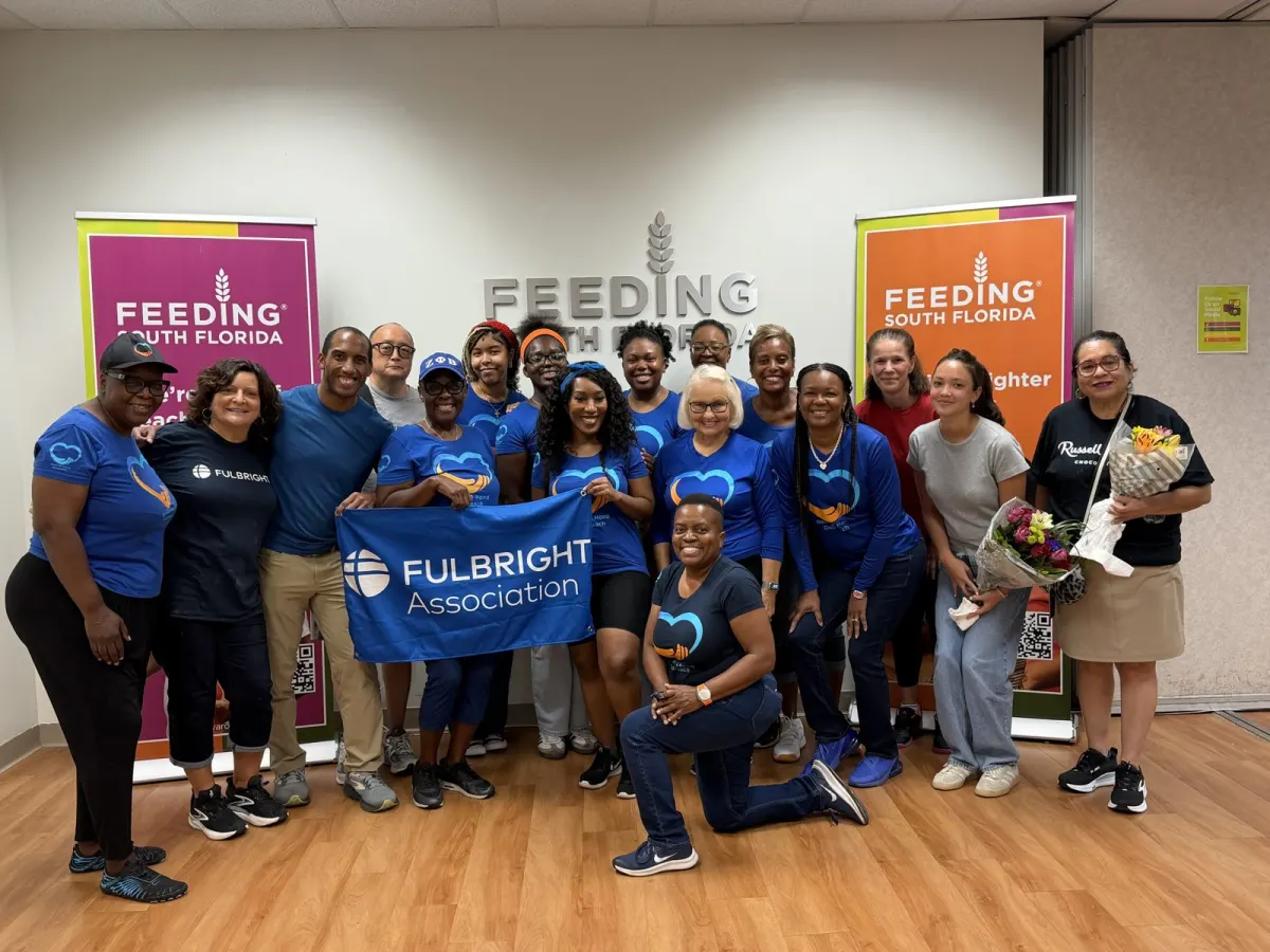 Feeding South Florida volunteers with the Fulbright Association banner in Pembroke Park, USA