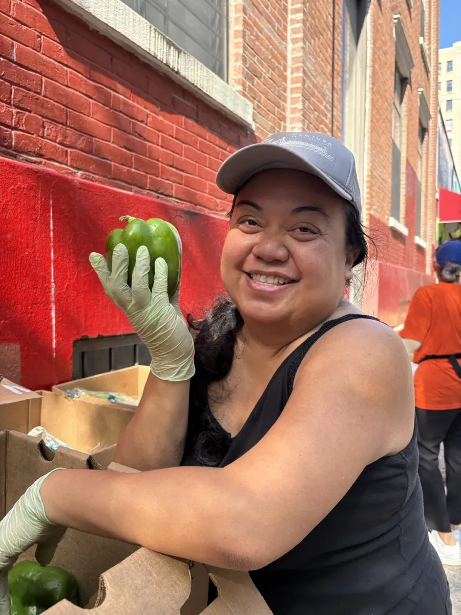 A volunteer at Nazareth Housing's Food Pantry Distribution in New York, USA